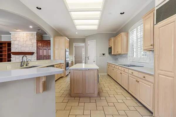 a kitchen with stainless steel appliances granite countertop a sink and cabinets