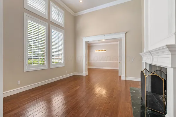 a view of a livingroom with wooden floor and a fireplace