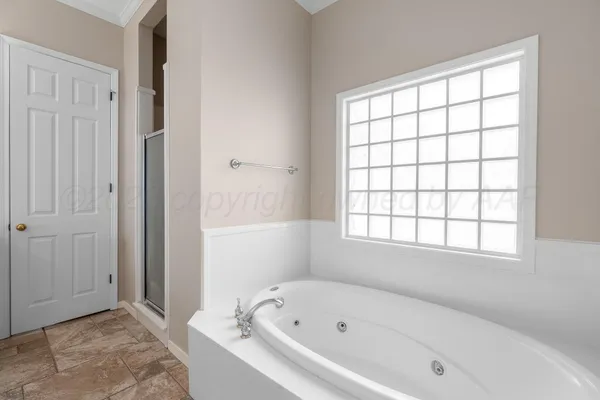 a white bath tub sitting next to a window