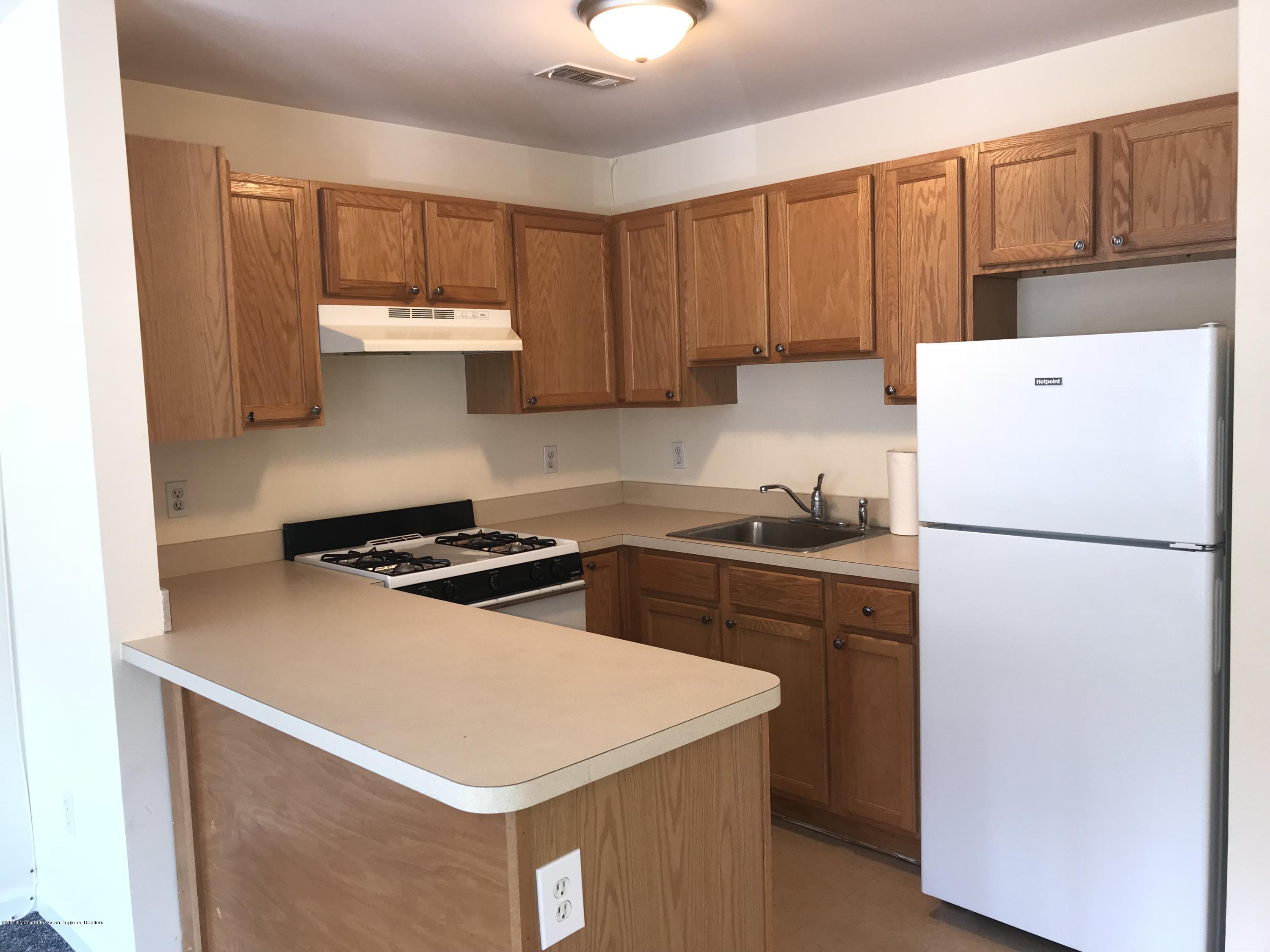 1508 Beaver Dam Road, Unit #6 Point Pleasant, NJ 08742 - Photo 6 of 7 a kitchen with a stove a refrigerator and a sink