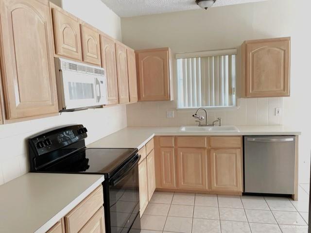 2917 North 43rd Street McAllen, TX 78501 - Photo 7 of 24 a kitchen with a sink and a stove top oven