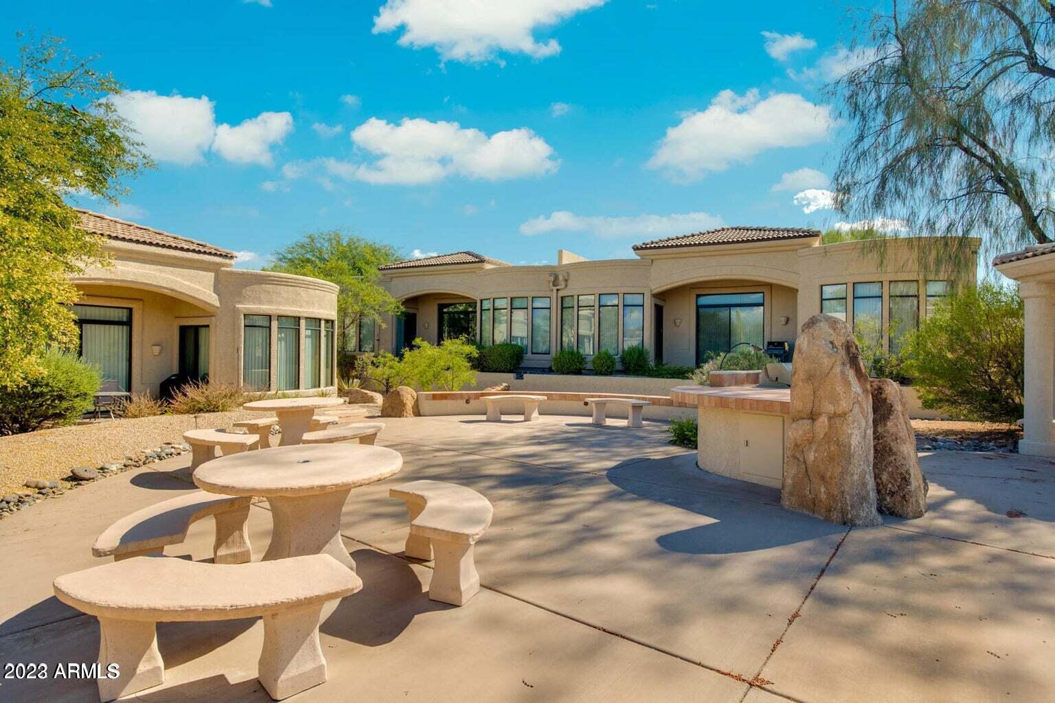 25603 North Sago Drive Rio Verde, AZ 85263 - Photo 17 of 25 a view of a patio with couches and table and chairs and potted plants