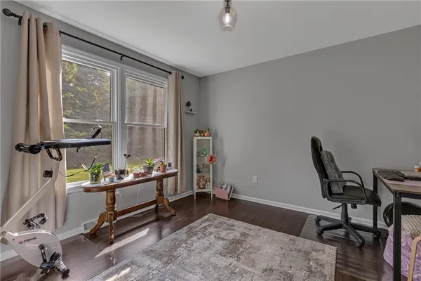 a view of a workspace with furniture and a window