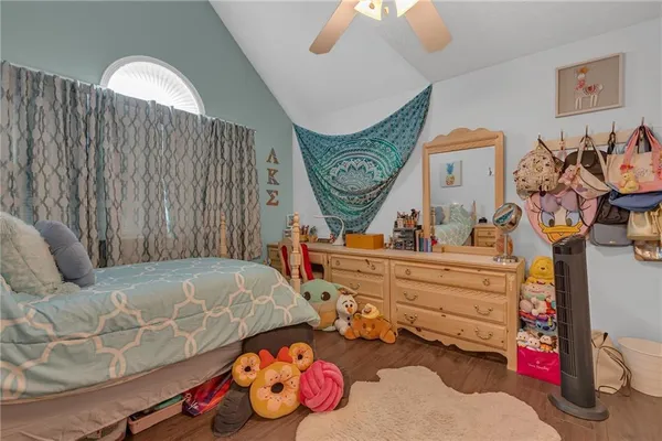 a bed room with a bed and a chair