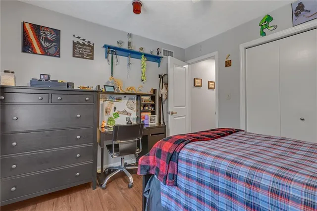 a bedroom with a bed and cabinets