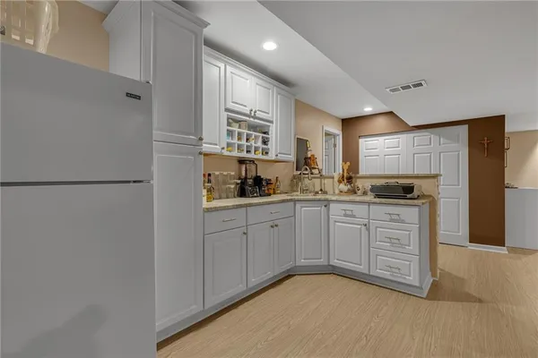 a kitchen with stainless steel appliances granite countertop a refrigerator sink and cabinets