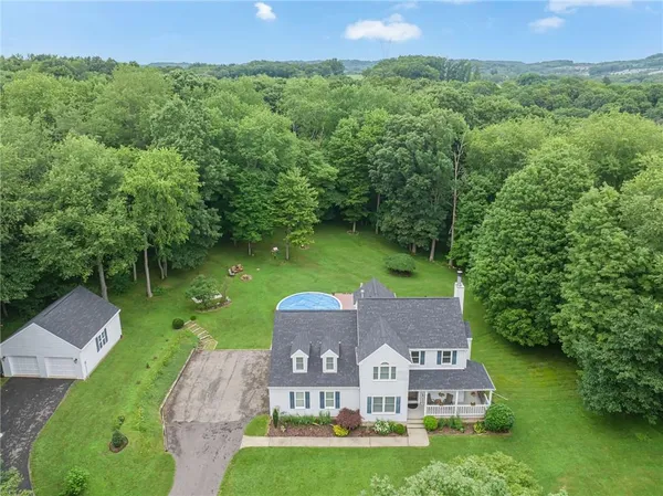 an aerial view of a house with a garden and a yard