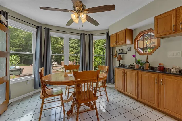a dining room with wooden floor a chandelier a wooden table and chairs