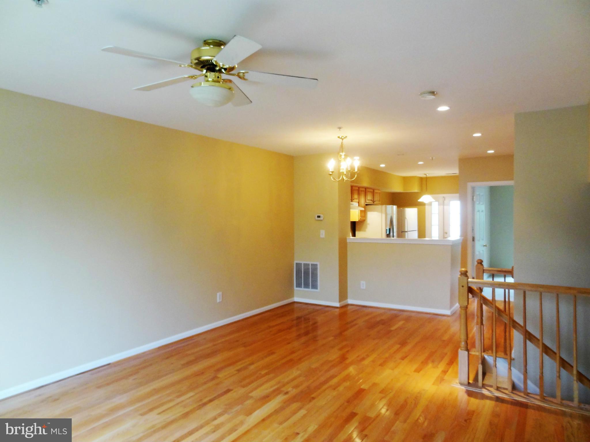 2032 University Boulevard West, Unit 3 Silver Spring, MD 20902 - Photo 2 of 16 a view of an empty room with window and wooden floor