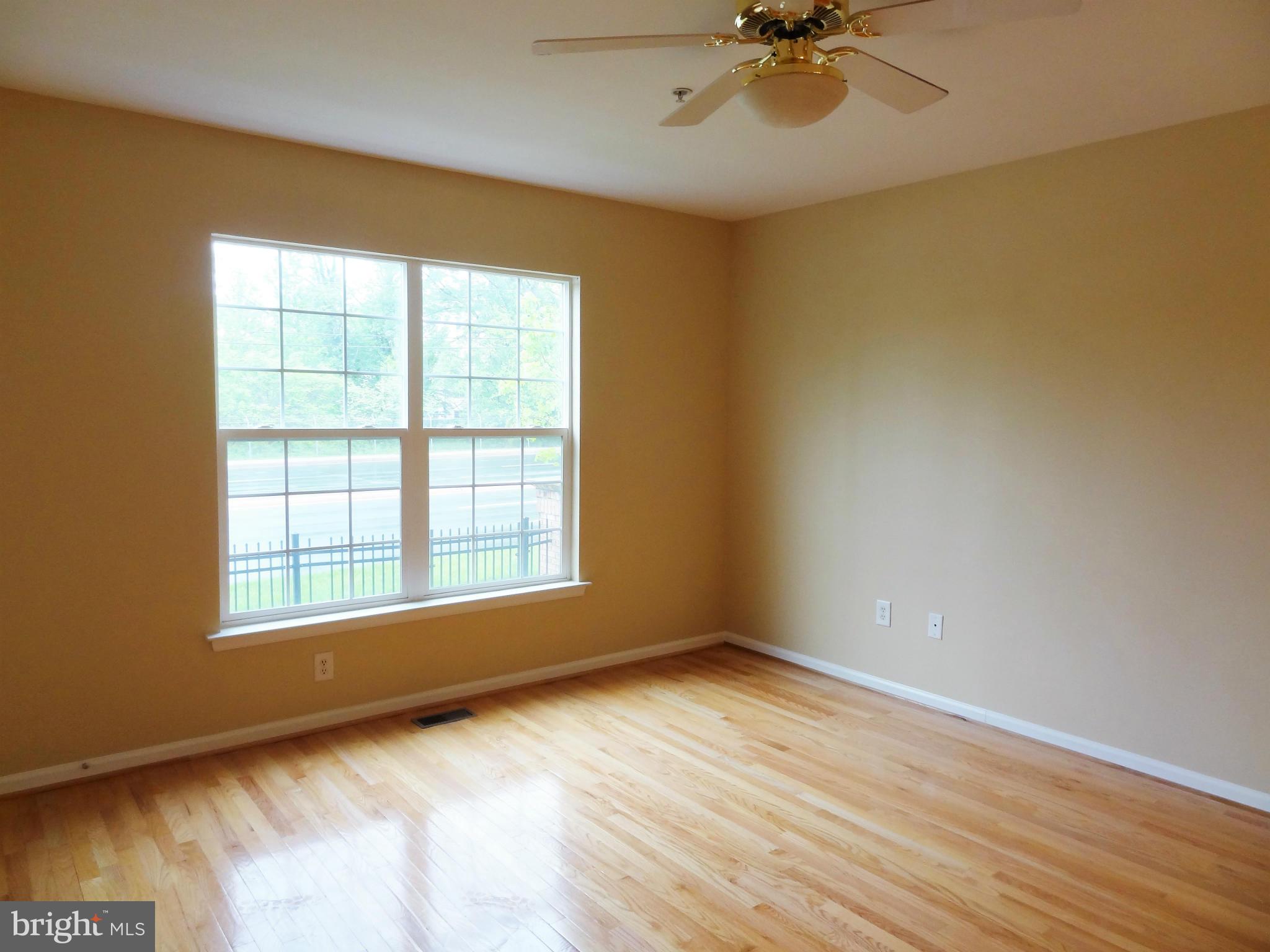 2032 University Boulevard West, Unit 3 Silver Spring, MD 20902 - Photo 3 of 16 wooden floor in an empty room with a window