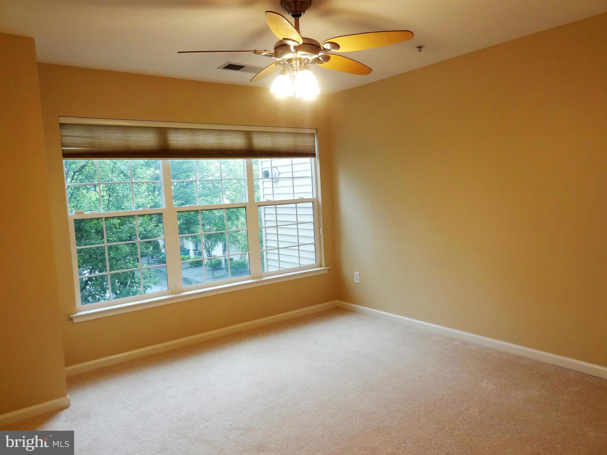 2032 University Boulevard West, Unit 3 Silver Spring, MD 20902 - Photo 8 of 16 an empty room with windows and fan