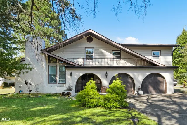 a front view of house with yard and green space