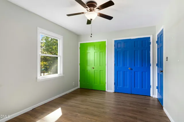 a view of empty room with window and ceiling fan