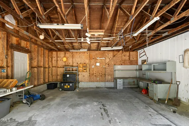 a view of house with backyard and sitting area