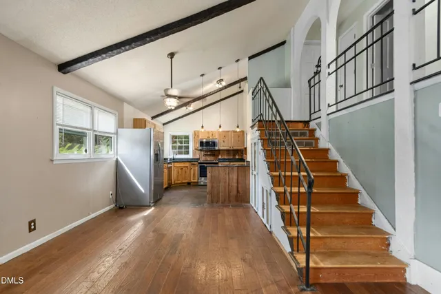 a view of entryway and hall with wooden floor