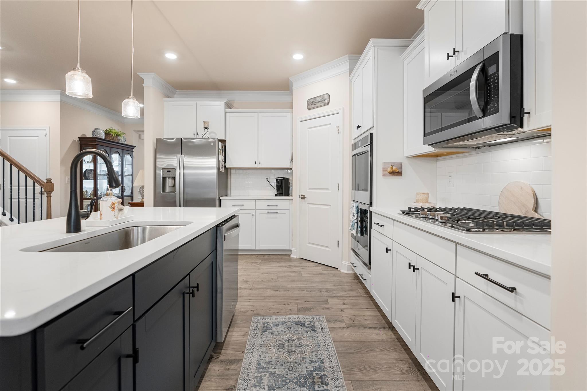 141 Rhuidean Court Troutman, NC 28166 - Photo 11 of 29 a kitchen with stainless steel appliances granite countertop a sink and stove top oven