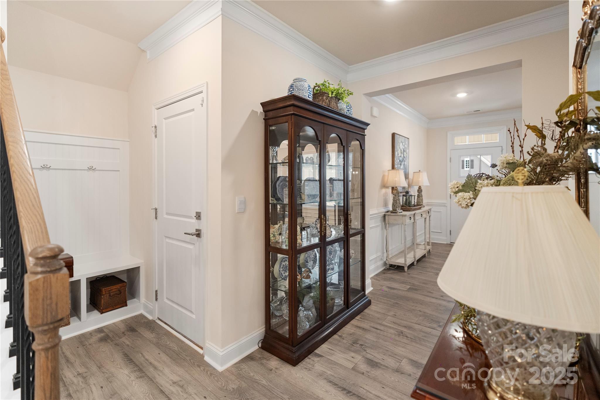 141 Rhuidean Court Troutman, NC 28166 - Photo 14 of 29 a view of a hallway with wooden floor and a living room