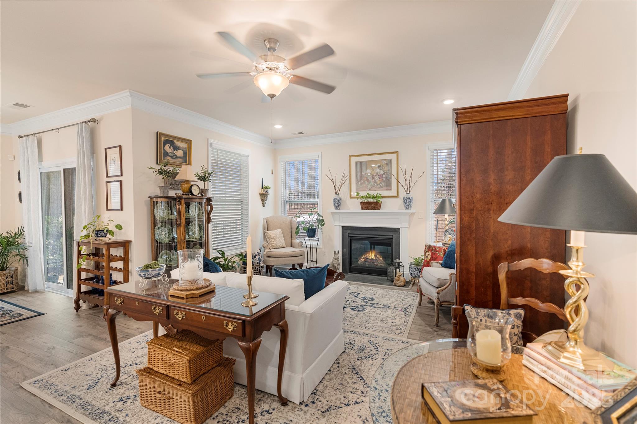 141 Rhuidean Court Troutman, NC 28166 - Photo 16 of 29 a living room with furniture a fireplace and a chandelier