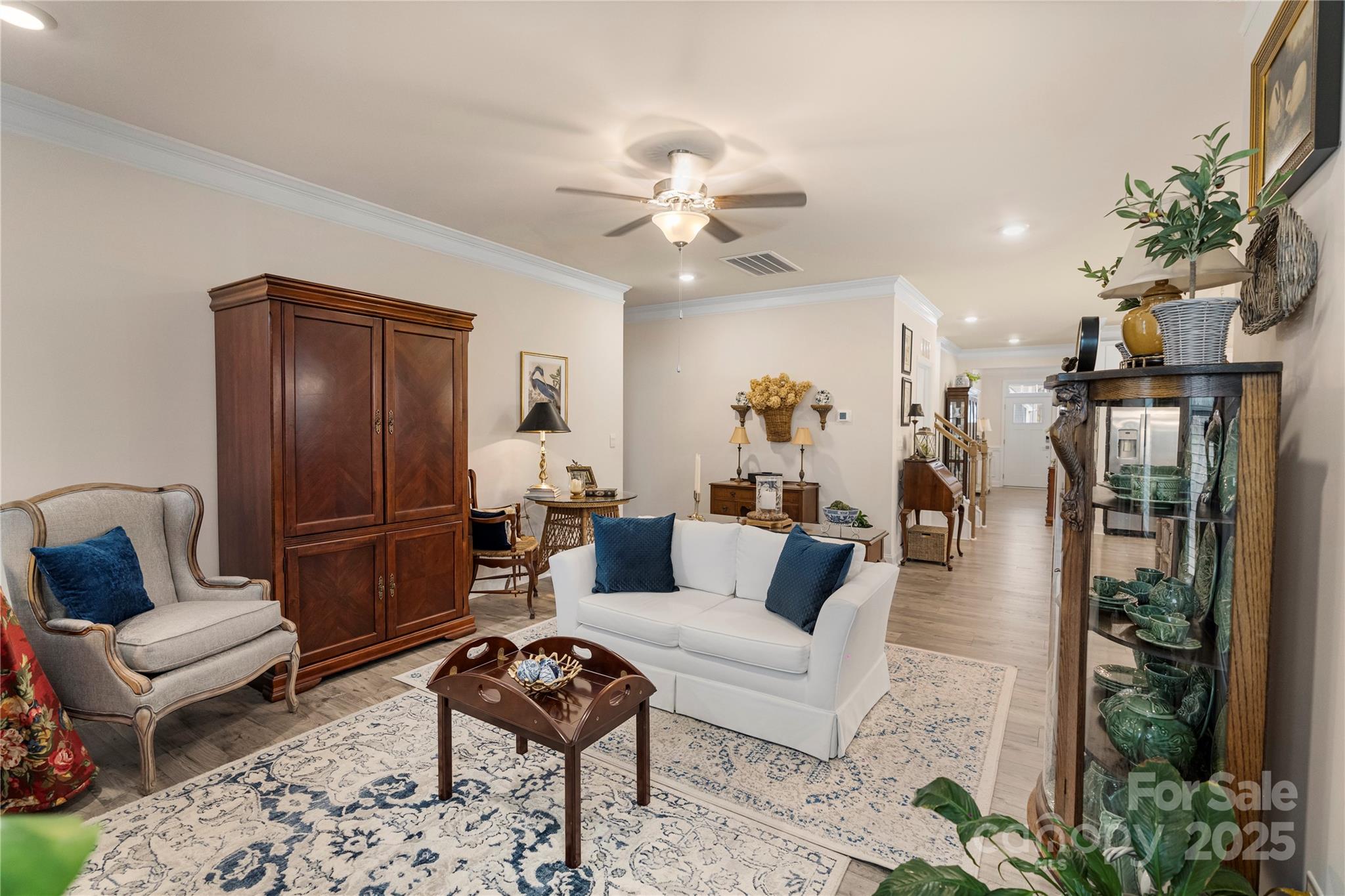 141 Rhuidean Court Troutman, NC 28166 - Photo 17 of 29 a living room with furniture a chandelier and a rug