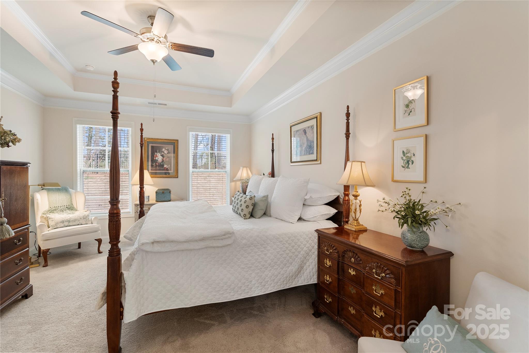 141 Rhuidean Court Troutman, NC 28166 - Photo 19 of 29 a bedroom with a bed potted plant on dresser and a chandelier