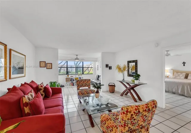 a living room with furniture a couch and a window