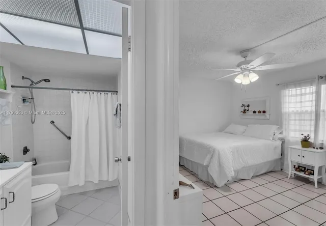 a spacious bathroom with a double vanity sink toilet and shower