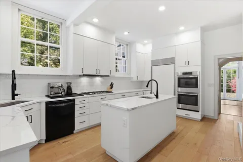 a kitchen with sink a stove and cabinets