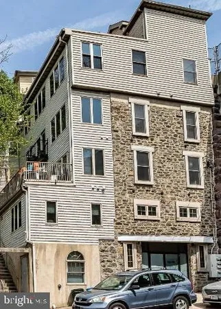 a front view of a residential apartment building with a yard