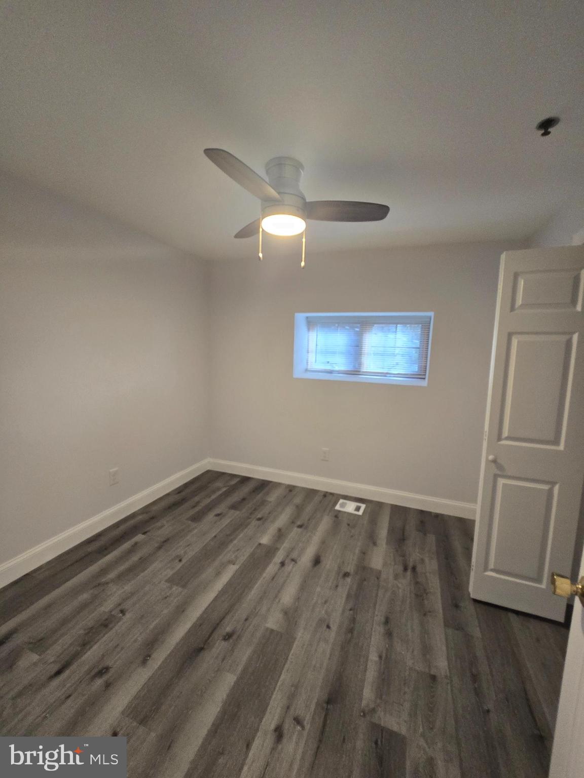 210 Shurs Lane, Unit 4 Philadelphia, PA 19128 - Photo 11 of 24 an empty room with wooden floor and window