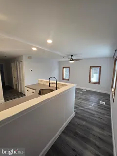 a view of a room with wooden floor