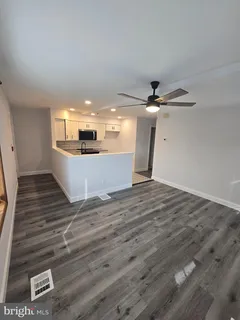 a view of a room with wooden floor