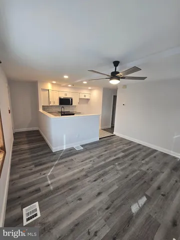 a view of a room with wooden floor