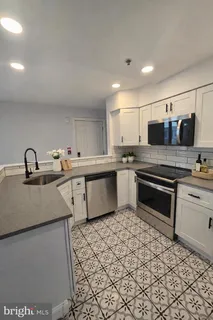 a kitchen with stainless steel appliances a sink and a stove