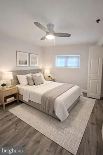 a bedroom with a bed and a night stand