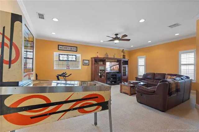 a living room with furniture a flat screen tv and a chandelier