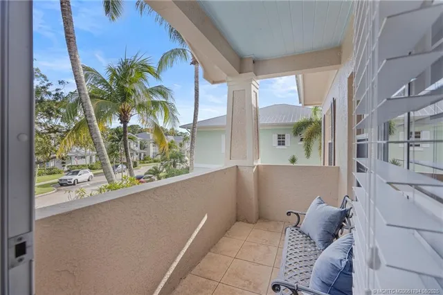 a living room with a couch and a potted plant
