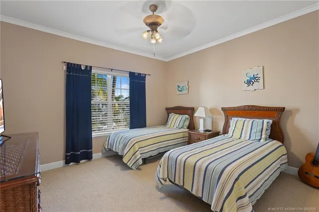 a bedroom with two beds and a chandelier