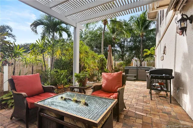 a outdoor sitting area with furniture and a potted plant