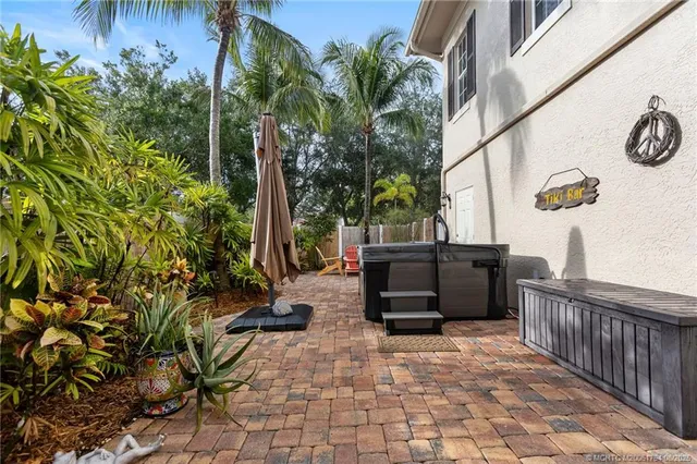 a living room with a couch and potted plants