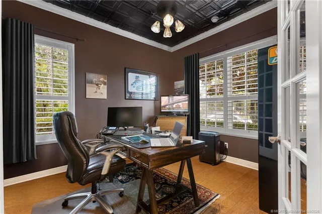 a view of a workspace with furniture and a window