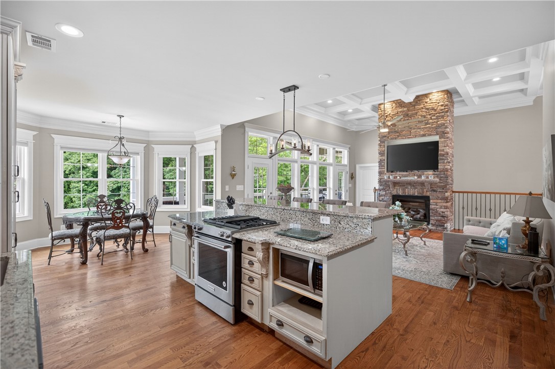 206 James Hare Road Anderson, SC 29626 - Photo 29 of 37 An open concept design seamlessly connects the gourmet kitchen to the sun-drenched living space, highlighting coffered ceilings.
