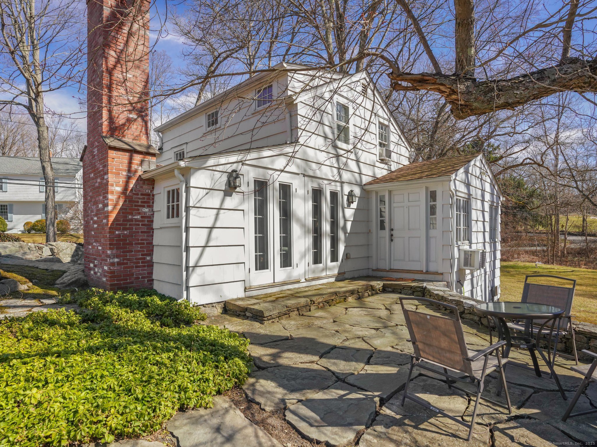 a view of a chairs and table in backyard
