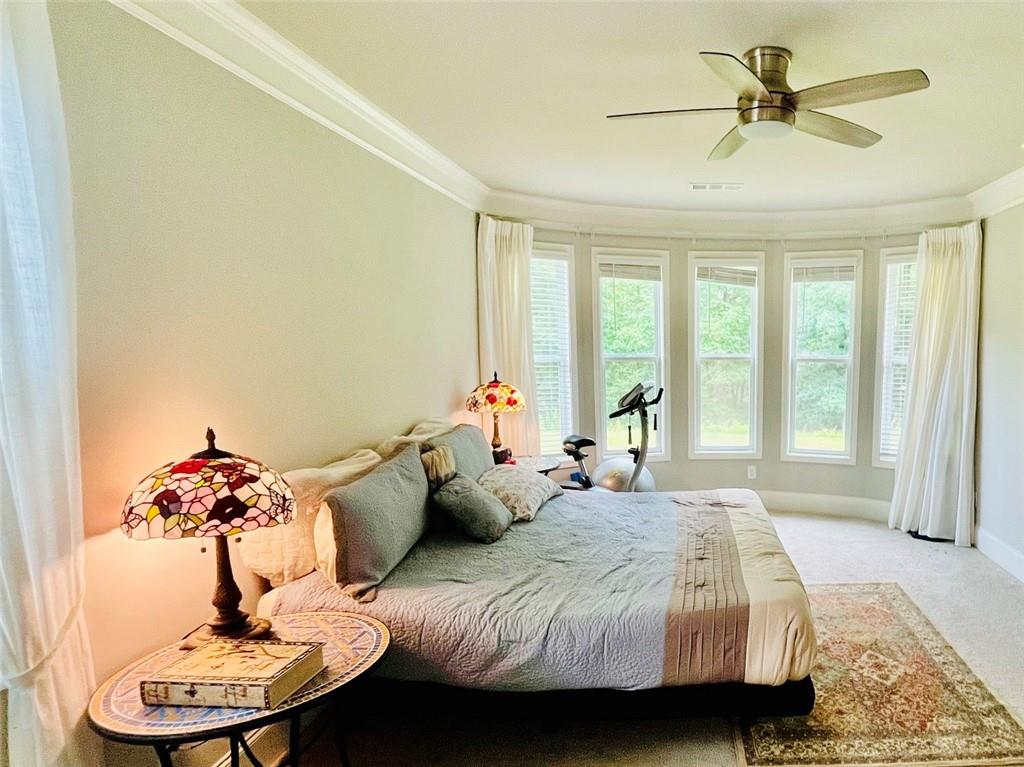 3015 Winding Ridge Waleska, GA 30183 - Photo 15 of 40 a bedroom with a bed and ceiling fan