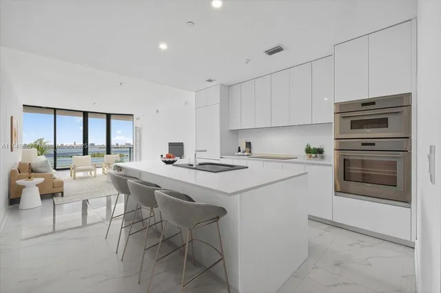 a kitchen that has a sink and a stove in it