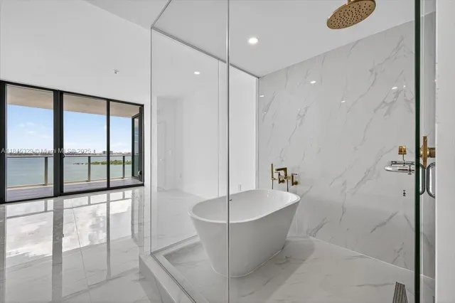a bathroom with a bathtub and shower