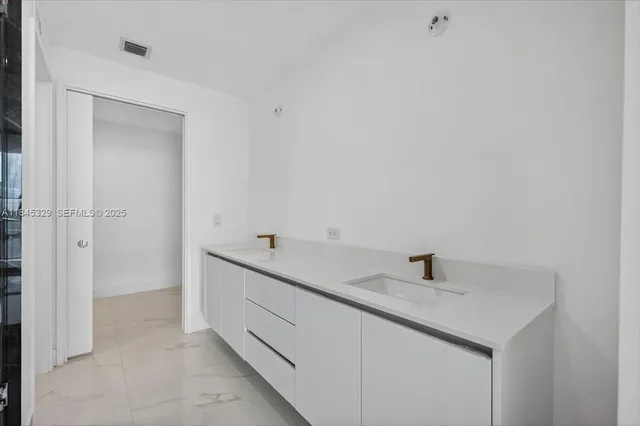 a bathroom with a sink and vanity