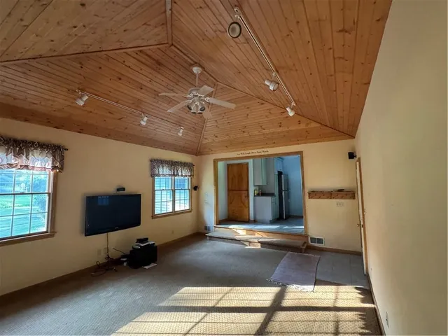 a bathroom with a sink toilet a mirror and shower