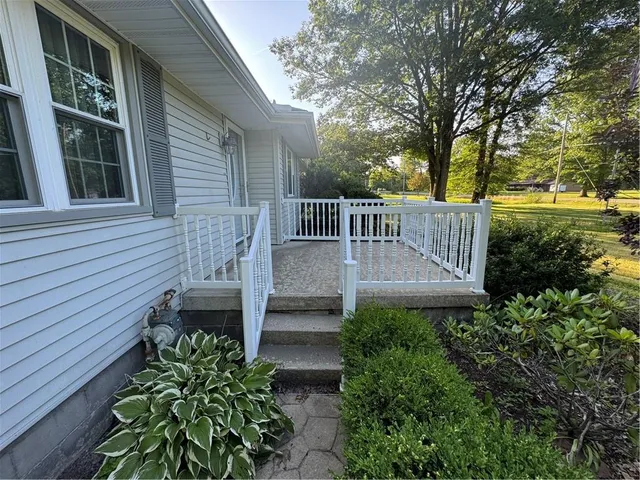a view of a wooden house with a yard