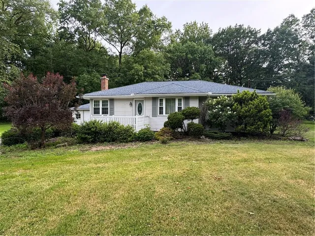 a front view of a house with a garden