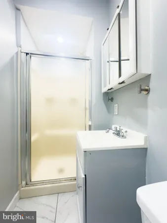 a bathroom with a sink mirror vanity and window